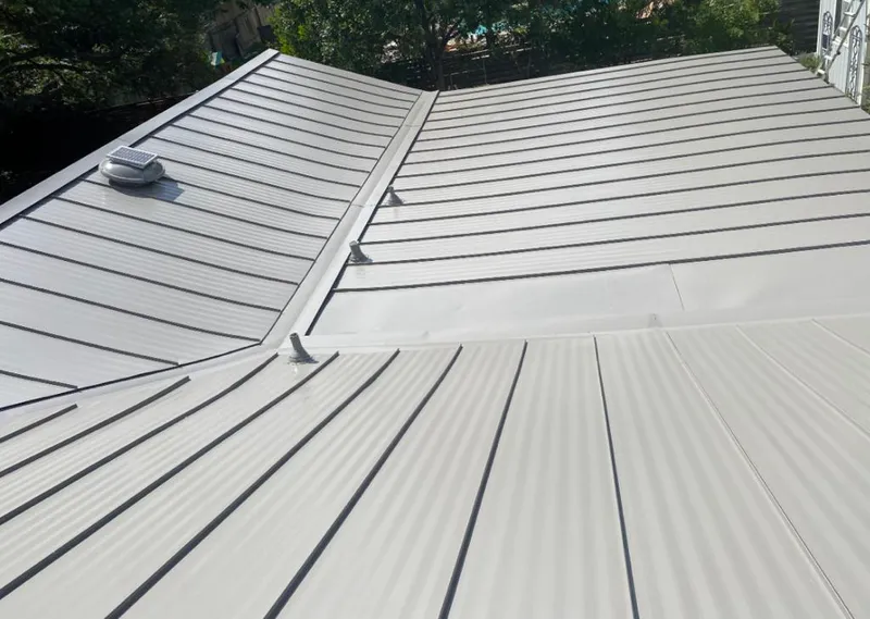 Solar attic fan installed on a metal roof for Roof Ventilation in East Renton Highlands