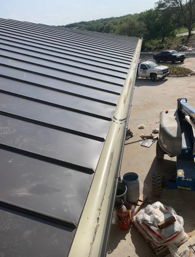 Standing seam panel and gutter detail on a metal roofing jobsite in East Renton Highlands